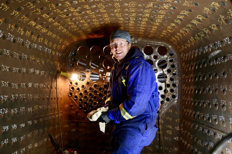 Brother Matt Wallace in the fire box rolling the tubes.