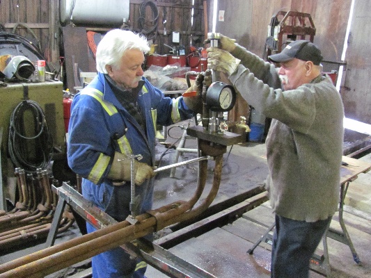 Mike Roxburgh and an I.H.S volunteer pressure testing the superheaters that are installed into the flue tubes