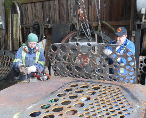 Sister Sarah Smith and Brother Barry Dobrensky preparing a tube sheet to be formed in shape.